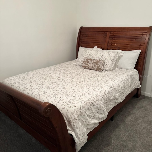 bedroom featuring dark colored carpet