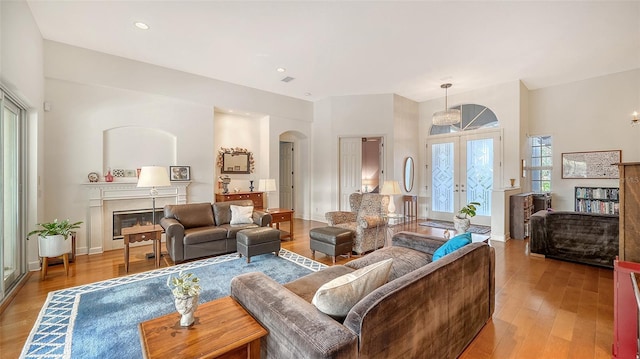 living room with french doors and light wood-type flooring