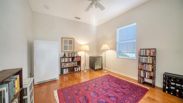 sitting room with ceiling fan and light hardwood / wood-style flooring