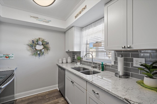 kitchen featuring white cabinetry, sink, tasteful backsplash, dark hardwood / wood-style flooring, and appliances with stainless steel finishes