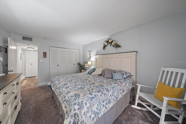 bedroom with dark carpet and a closet