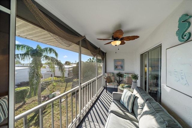 sunroom / solarium featuring ceiling fan