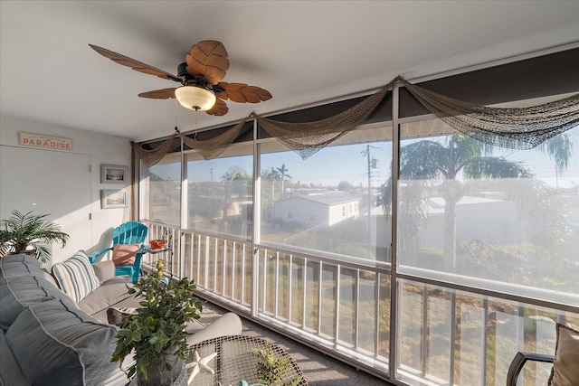 unfurnished sunroom featuring ceiling fan and a healthy amount of sunlight