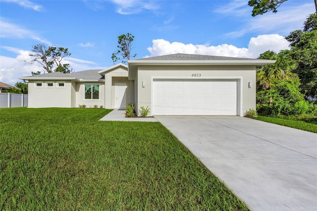 view of front of house with a front yard and a garage