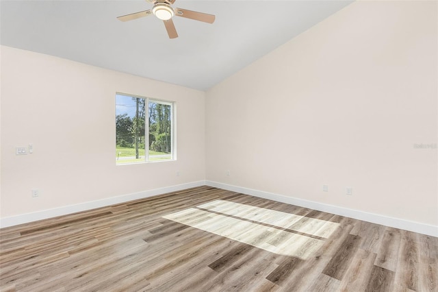 empty room featuring light hardwood / wood-style flooring, ceiling fan, and lofted ceiling