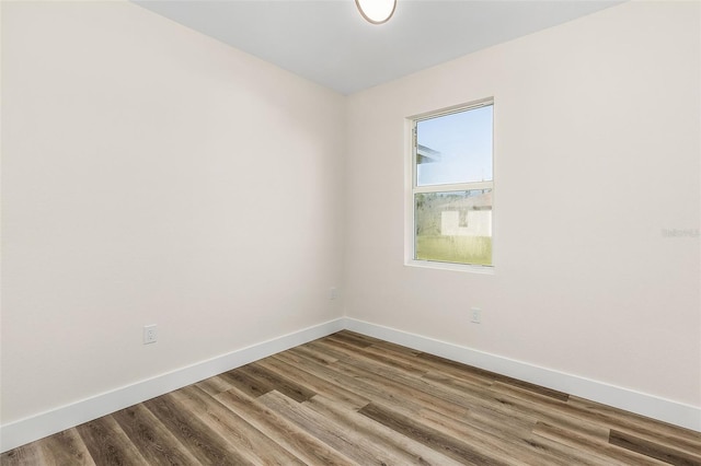 unfurnished room with hardwood / wood-style floors