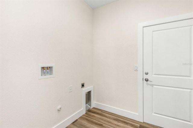 washroom with hookup for a washing machine, light wood-type flooring, gas dryer hookup, and electric dryer hookup