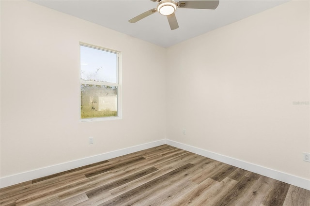 empty room featuring ceiling fan and hardwood / wood-style floors