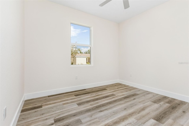 spare room featuring light hardwood / wood-style floors and ceiling fan