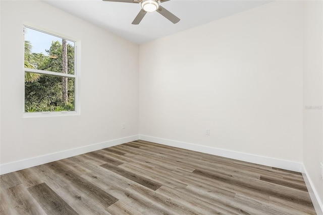 spare room with hardwood / wood-style floors and ceiling fan