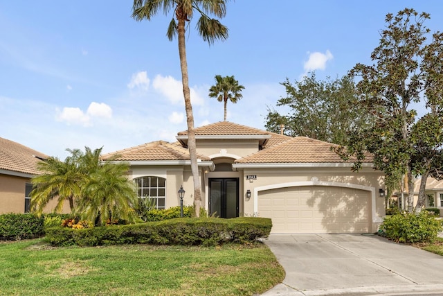 mediterranean / spanish-style house featuring a garage and a front lawn