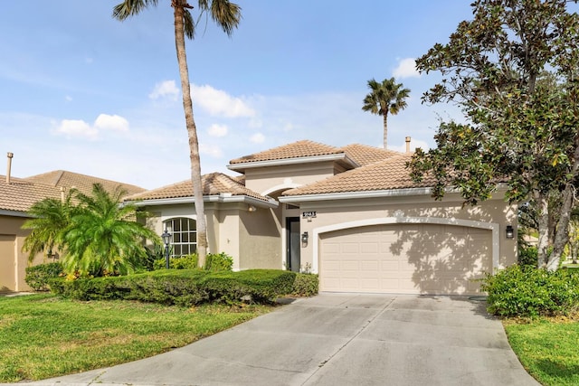 mediterranean / spanish home featuring a garage and a front lawn