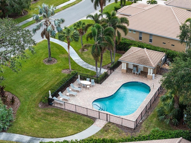 view of swimming pool featuring a patio and a lawn