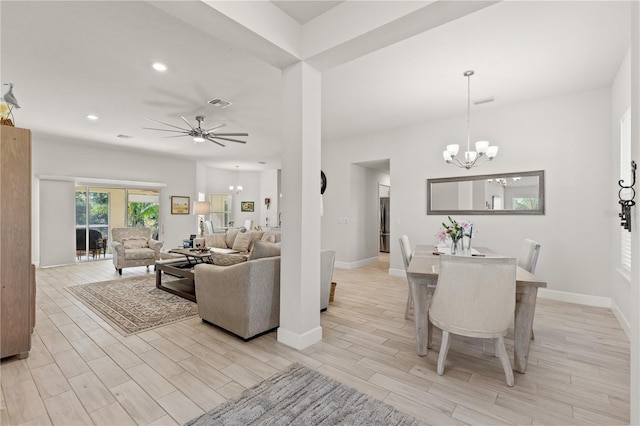 living room featuring ceiling fan with notable chandelier, light wood-type flooring, visible vents, and baseboards