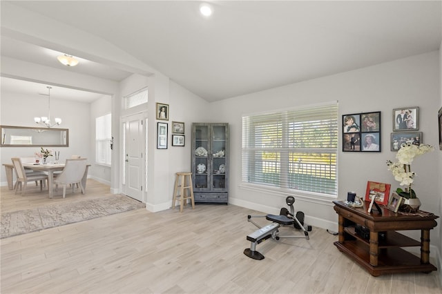 workout room with vaulted ceiling, baseboards, wood finished floors, and a notable chandelier