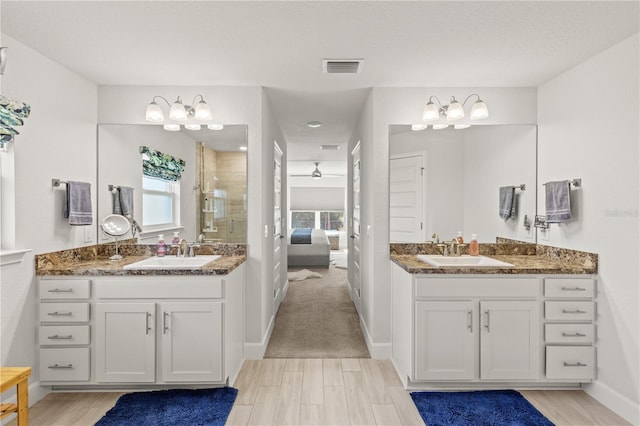 full bathroom with a healthy amount of sunlight, a stall shower, visible vents, and a sink