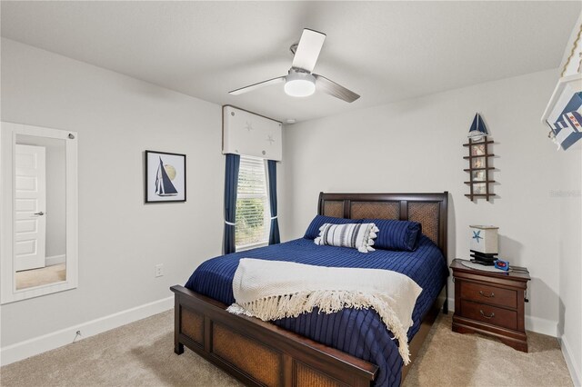 carpeted bedroom featuring ceiling fan and baseboards