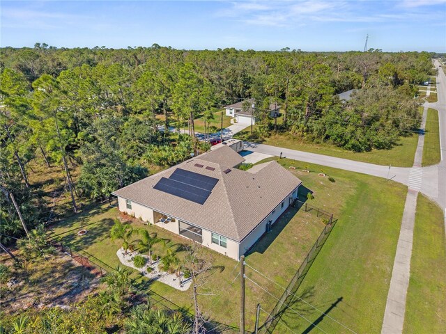 drone / aerial view with a wooded view