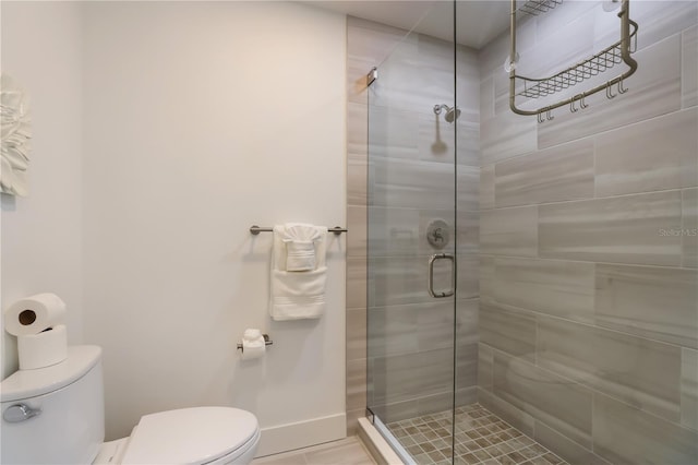 bathroom featuring toilet and walk in shower