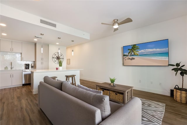 living room with ceiling fan, dark hardwood / wood-style flooring, and sink