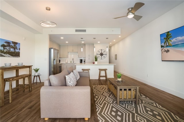 living room with dark hardwood / wood-style floors and ceiling fan