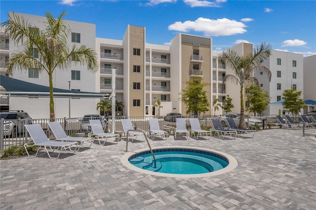 view of swimming pool with a community hot tub and a patio