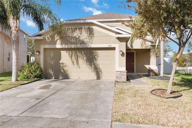 view of front facade with a garage and a front lawn