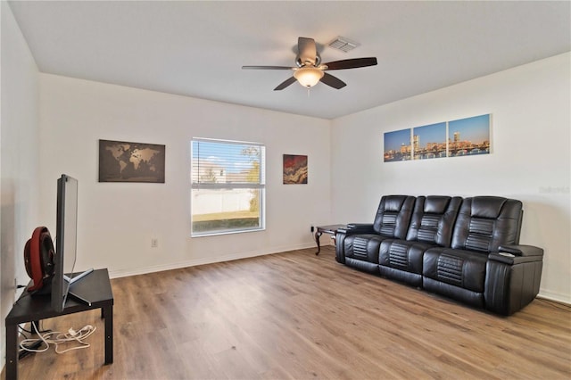 living room featuring ceiling fan and wood-type flooring