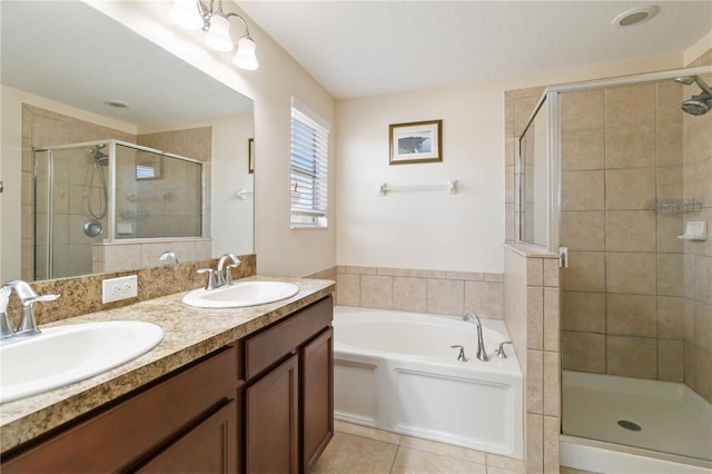 bathroom with tile patterned flooring, shower with separate bathtub, vanity, and a textured ceiling