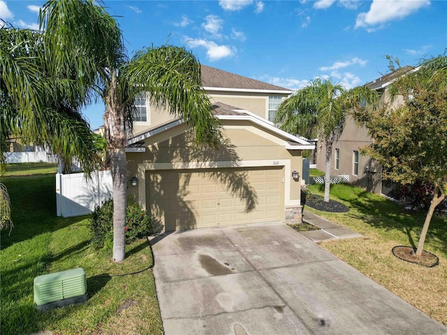 view of front of home featuring a front lawn and a garage