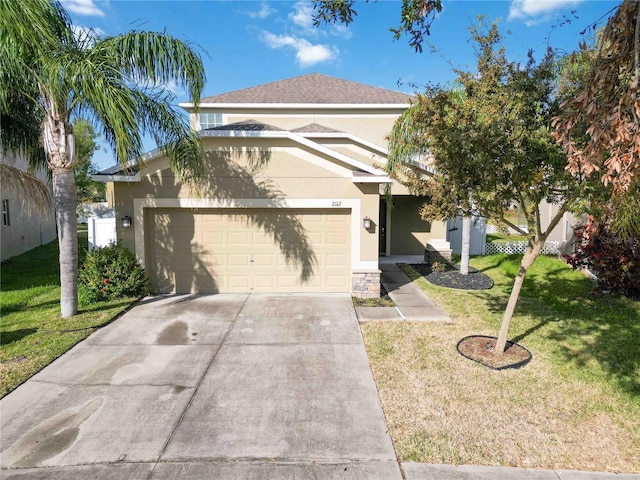 view of front of home with a front yard and a garage