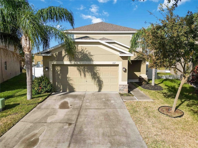 view of front of property featuring a garage and a front lawn