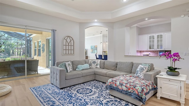 living room featuring crown molding and light wood-type flooring