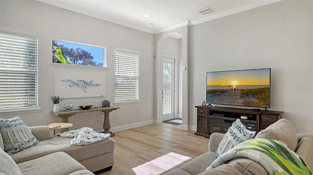 living room featuring light hardwood / wood-style floors and crown molding