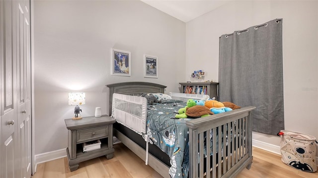 bedroom with a closet and light hardwood / wood-style flooring