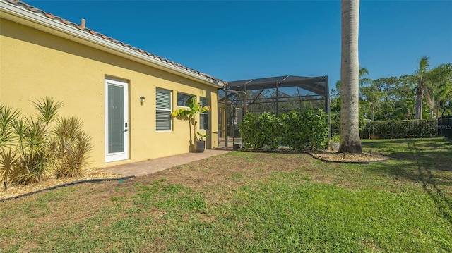 view of yard featuring glass enclosure