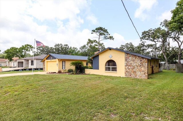 ranch-style home featuring a front yard and a garage