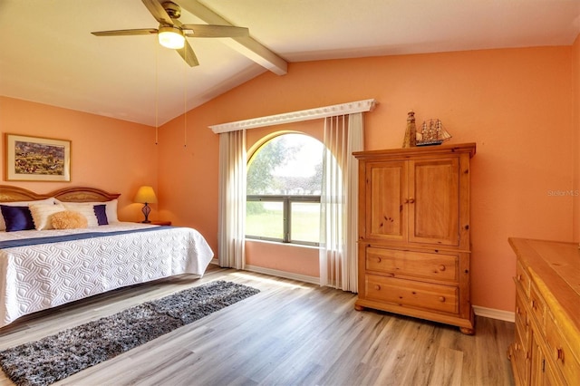 bedroom with lofted ceiling with beams, light hardwood / wood-style floors, and ceiling fan