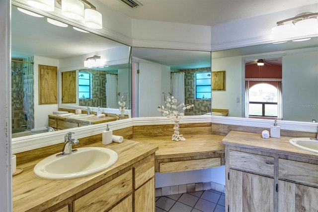 bathroom with tile patterned flooring, vanity, toilet, and ceiling fan