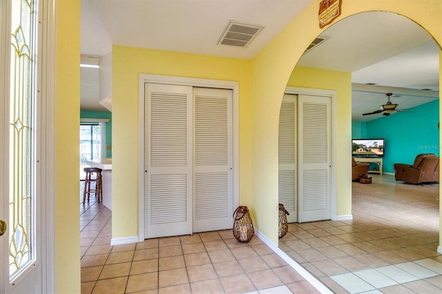 interior space with ceiling fan