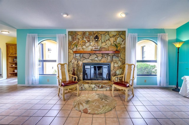 living area featuring light tile patterned floors and a fireplace