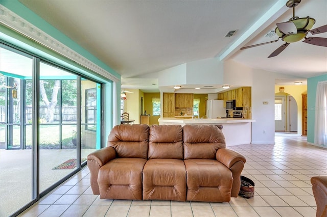 living room featuring light tile patterned floors, lofted ceiling with beams, and ceiling fan