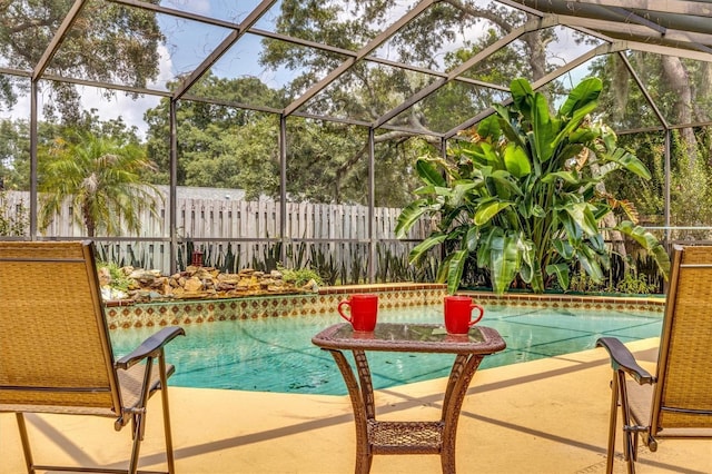 view of swimming pool featuring a lanai and a patio area