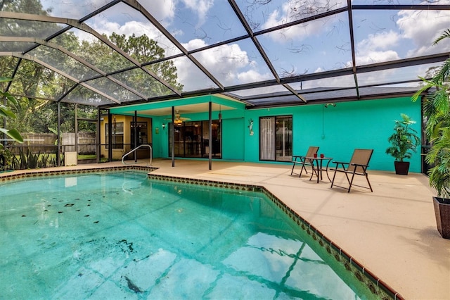 view of pool with ceiling fan, a lanai, and a patio