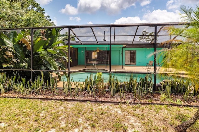 view of pool with glass enclosure