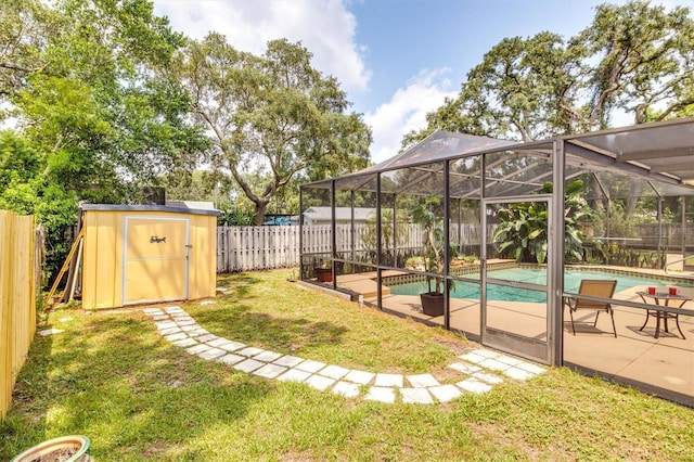 view of yard featuring a fenced in pool, a patio area, glass enclosure, and a shed