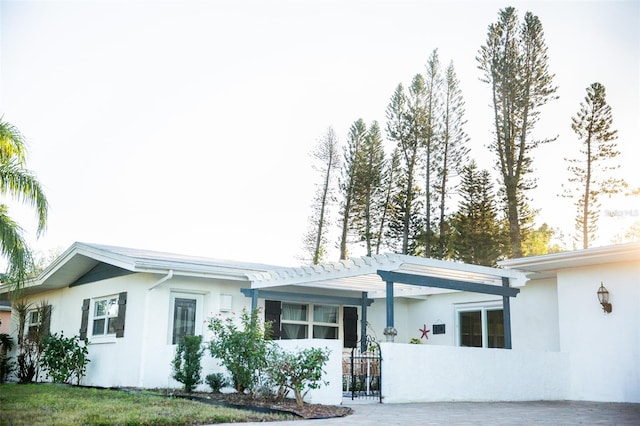 single story home with a pergola