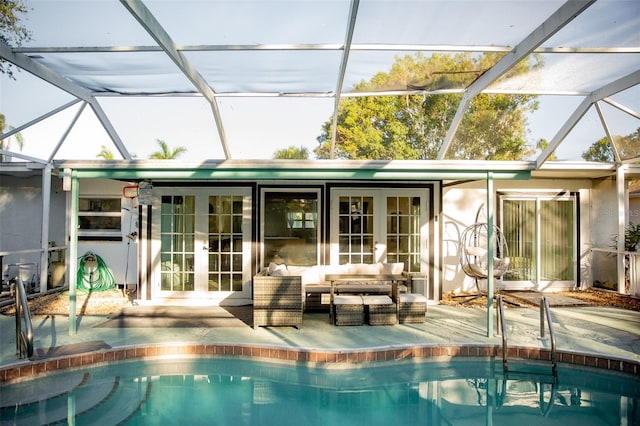 view of swimming pool with a lanai, a patio area, french doors, and an outdoor hangout area