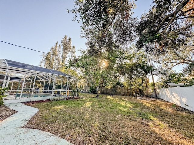 view of yard featuring glass enclosure