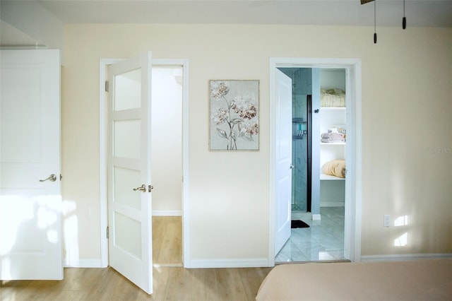 unfurnished bedroom featuring light hardwood / wood-style flooring and ensuite bath